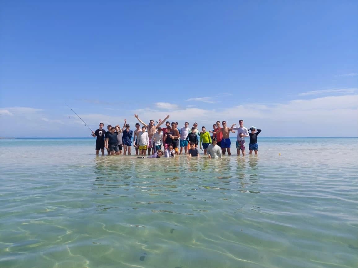 Our previous group enjoying clear water at the beach